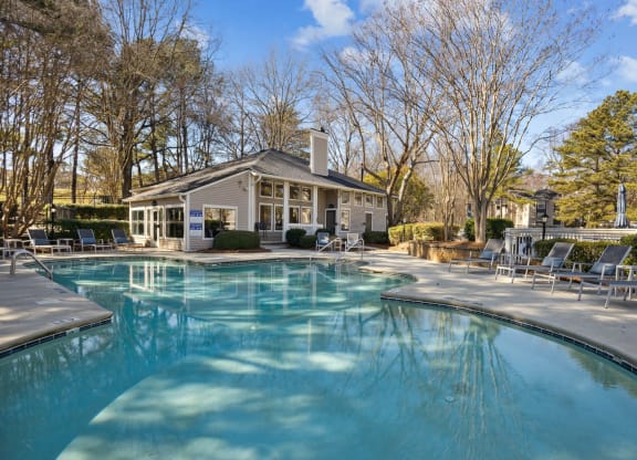 a swimming pool with a house in the background