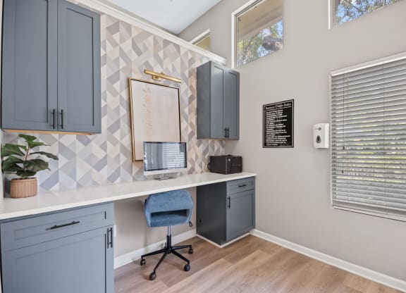 an office with a desk and a chair and a window