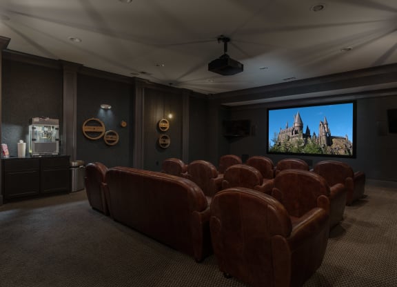 a large screening room with leather seats and a projector screen at Hayden Lofts, Dublin, OH
