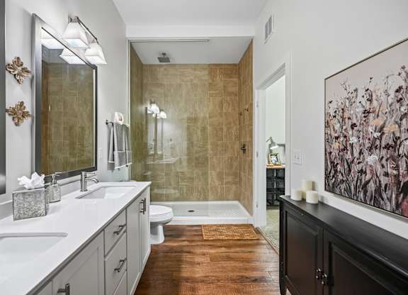 A bathroom with a brown floor and a brown shower.