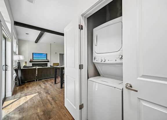 A modern kitchen with a washing machine built into the cabinetry.