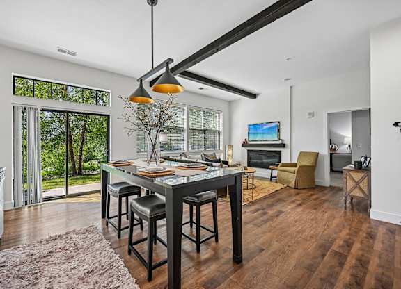 A modern kitchen with a dining table and chairs.