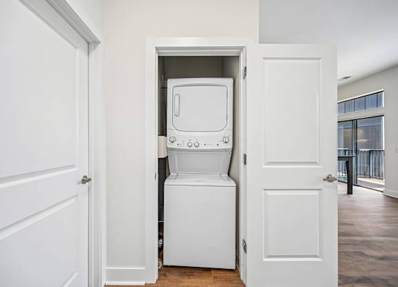 A white toilet is installed in a small alcove in a home.