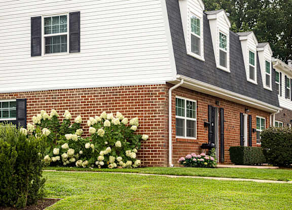A white house with a black door and windows.