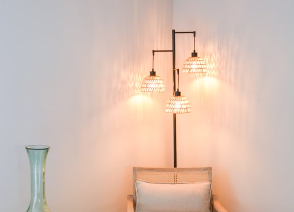 a small chair and a vase in a bedroom