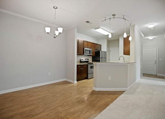 A kitchen area with a bar counter and a dining table.