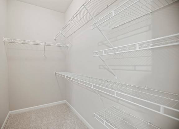 Empty white shelves in a room.