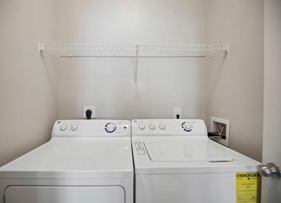 A white washing machine and dryer in a laundry room.