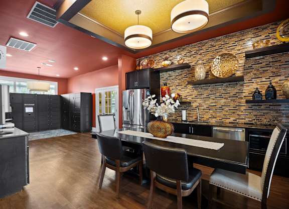 A modern kitchen with a dining table and chairs.
