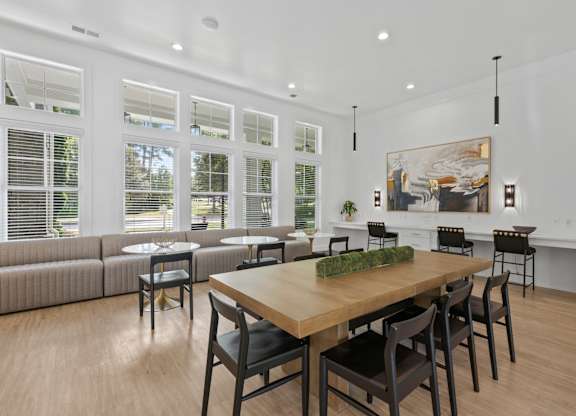 A dining room with a wooden table and chairs.