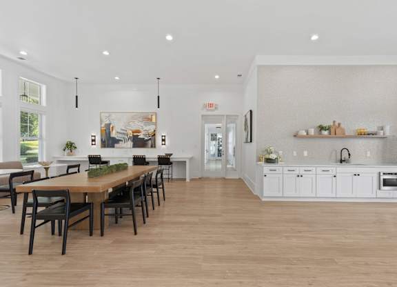 A modern kitchen with a dining table and chairs.