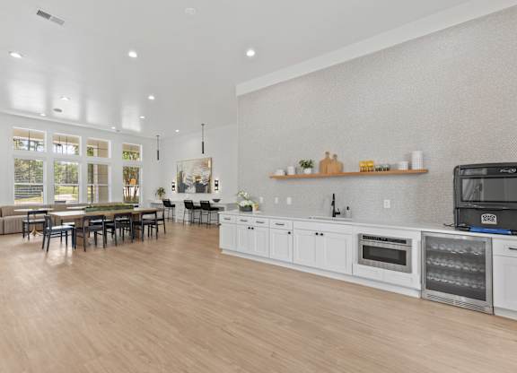 A modern kitchen with a dining table and chairs.
