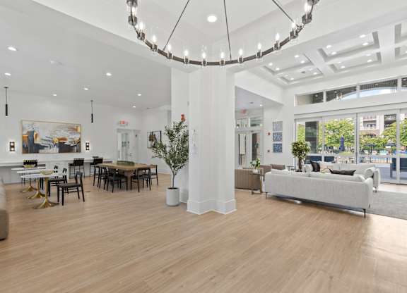 A large, well-lit room with a wooden floor and furniture.