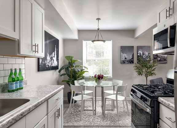 A modern kitchen with a dining table and chairs.