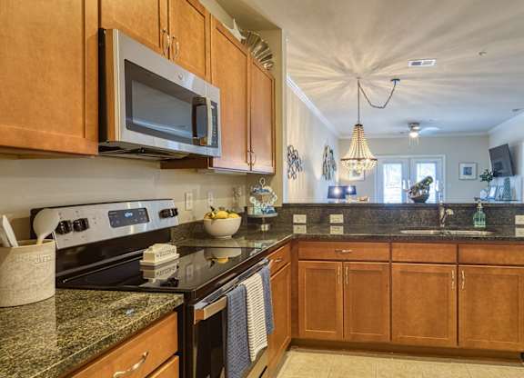 A kitchen with wooden cabinets and granite countertops.