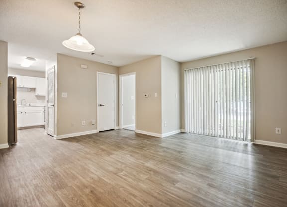 an empty living room with a large window