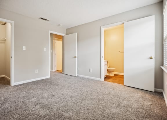 a bedroom with two doors and a toilet