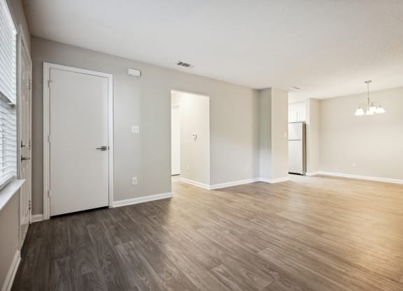 an empty living room with a hardwood floor