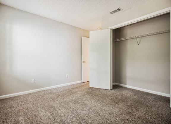 a bedroom with a closet and a window