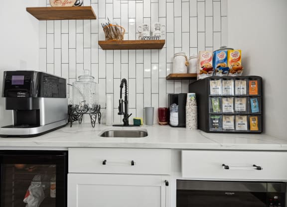 a kitchen with white cabinets and a white tile backsplash