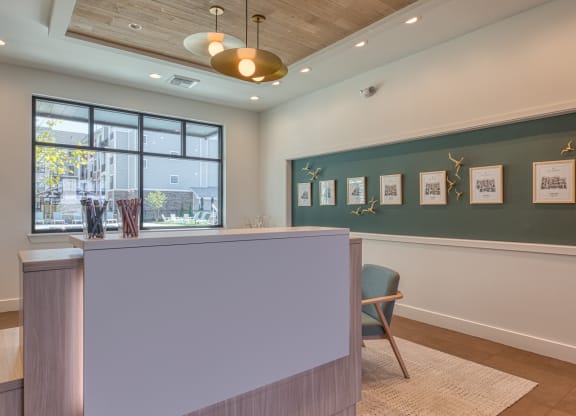 a reception area with a green wall and a desk with a chair