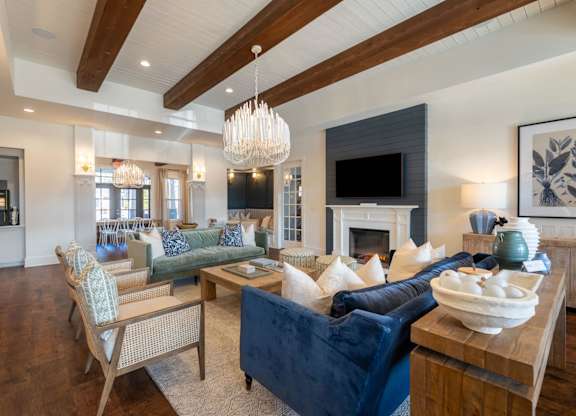 A living room with a fireplace and a blue couch.
