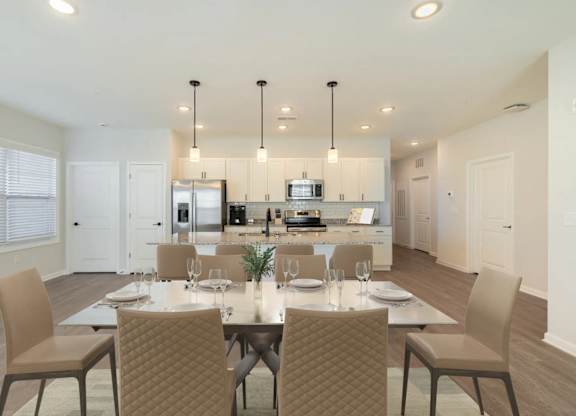 A modern dining room with a table set for four.