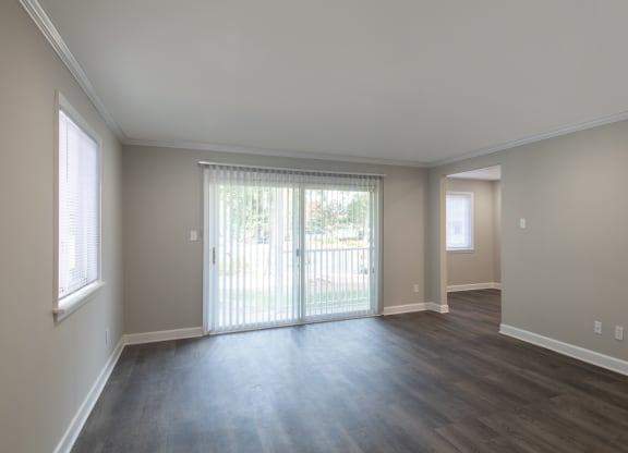 an empty living room with a sliding glass door
