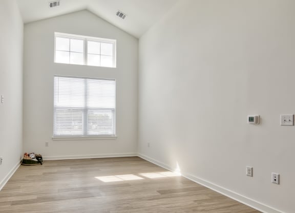 an empty room with white walls and a window at Allure at Edinburgh, Chesapeake, VA, 23322