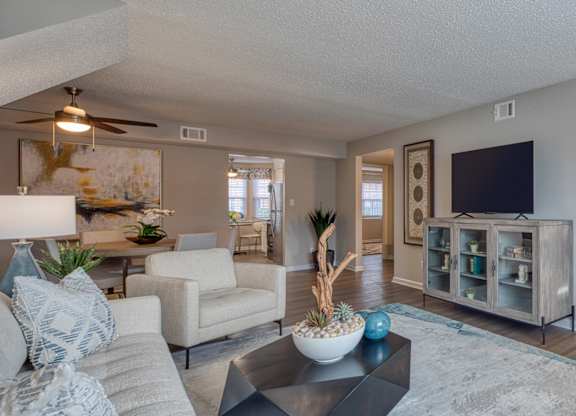 A living room with a couch, chair, and a coffee table.