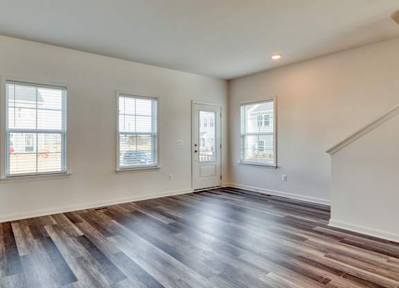 Living room with a large window and a wooden floor at The Mark, Harrisonburg, VA, Virginia