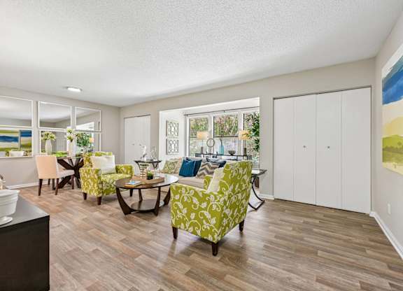 A living room with a dining table and chairs.