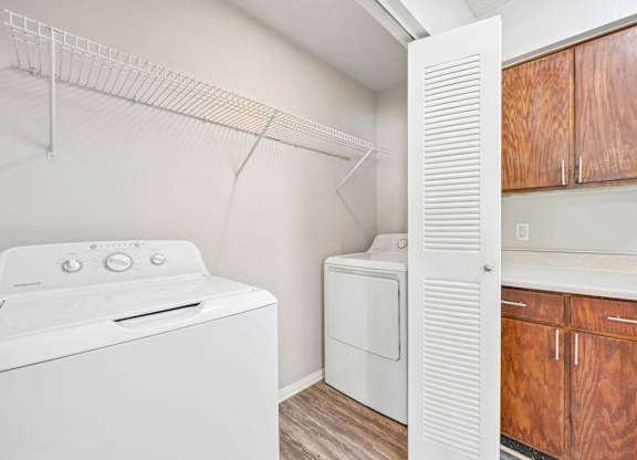 A white oven and dryer in a small kitchen.