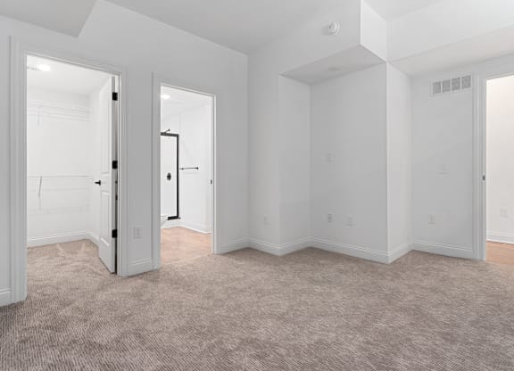 an empty living room with white walls and carpet at The Madison, Ohio, 43215