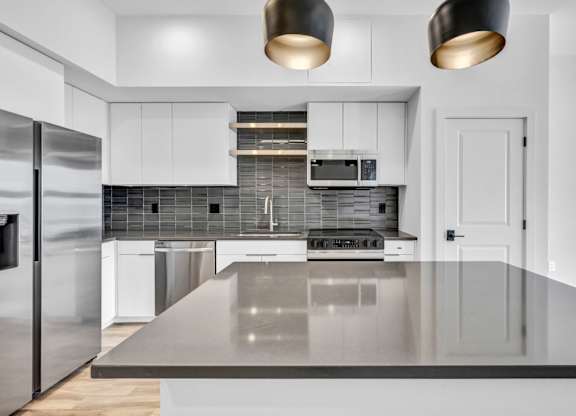 A modern kitchen with a large island in the middle.