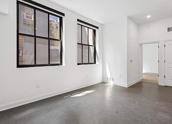 A room with a large window and a door.
