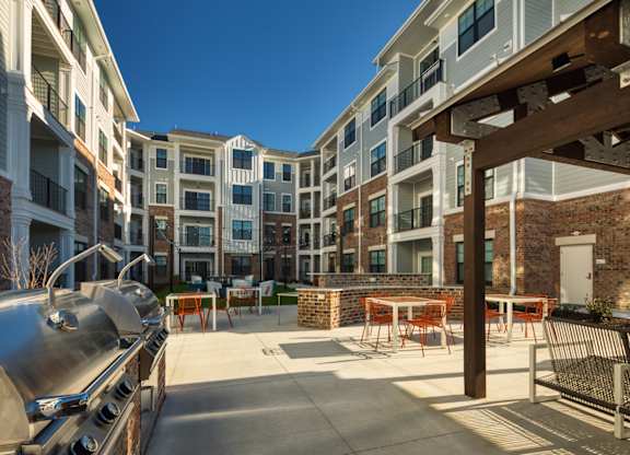 A sunny day at the outdoor seating area of a modern apartment complex.