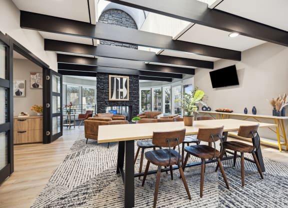 a dining room and living room with a large table and chairs