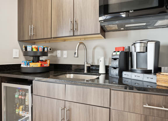 a kitchen with a sink and a coffee maker on the counter