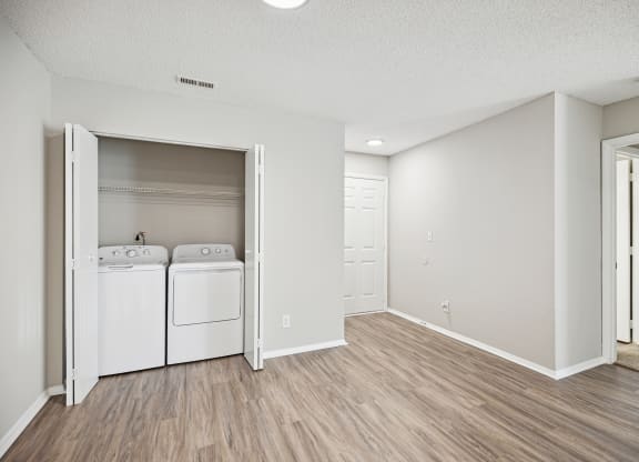 the spacious living room and laundry room with washer and dryer
