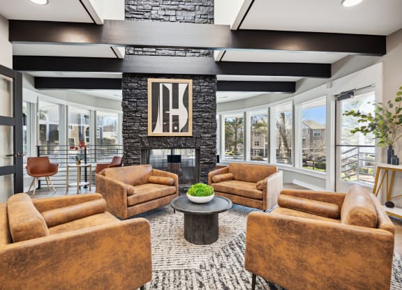 a living room with couches and chairs and a fireplace