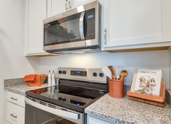 a kitchen with granite counter tops and a stove and microwave