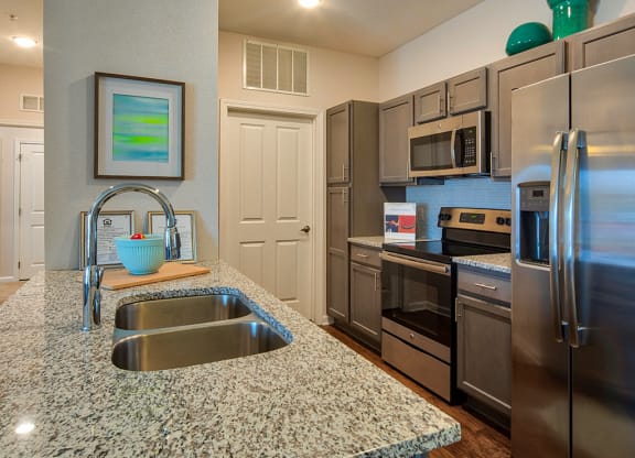Kitchen with granite counters at The Choices Apartments