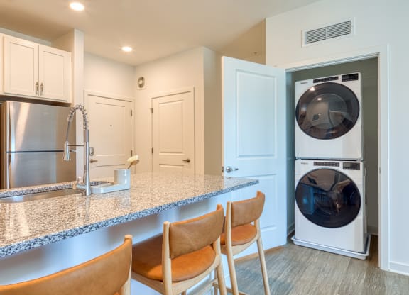a kitchen with a counter top and a washer and dryer