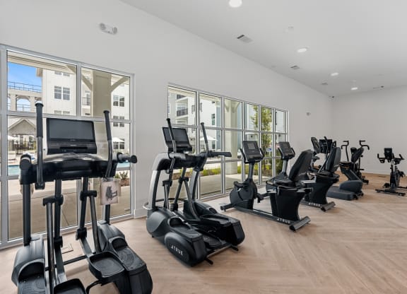 the gym with treadmills and ellipticals at the adagio apartmentsat Oak Grove at Blake Farm, Wilmington, 28411