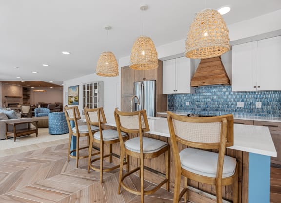 a kitchen with a bar with chairs and a dining tableat Oak Grove at Blake Farm, Wilmington, NC