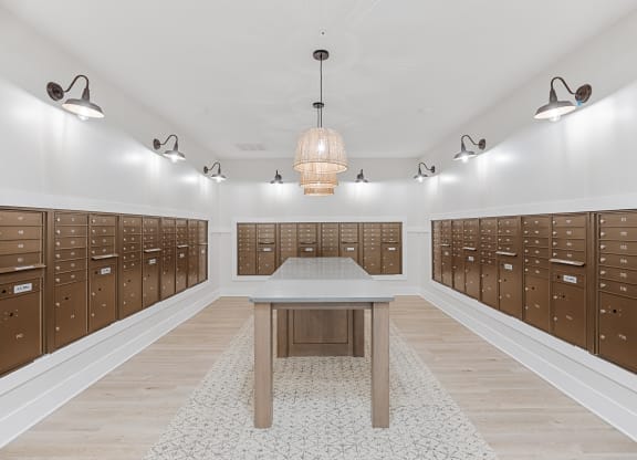 a locker room with wooden lockers and a tableat Oak Grove at Blake Farm, Wilmington, NC
