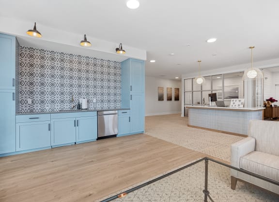 a kitchen and living room with blue cabinetsat Oak Grove at Blake Farm, Wilmington, North Carol