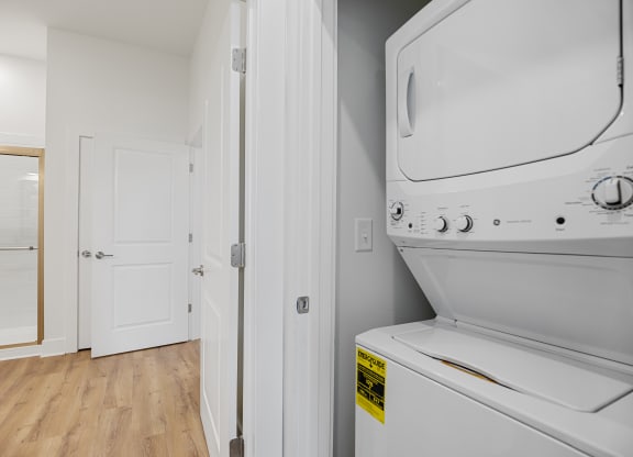 a laundry room with a washer and dryer and a door to a bathroomat Oak Grove at Blake Farm, Wilmington, 28411