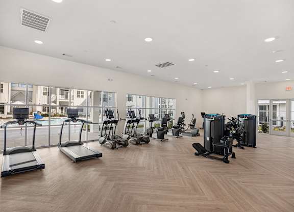 the gym with cardio machines and weights at the belgard apartments at Blake Farm, North Carolina